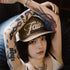 Person wearing a cap with 'Faith' text, surrounded by tattoos on arms and legs.